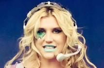 Pop artist Kesha decorated in glitter and dollar signs singing on stage (Kesha_2011_2.jpg: Peter Neillderivative work: Tabercil/Wikipedia Commons).