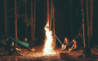 Campers sit around the fire enjoying the hammocks they decided to bring. ( Casey Garner/ Creative Commons)