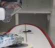 Blake Hansen buffs out a board at the shop in Oceanside, California. (Timmy Heffernan)