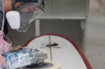 Blake Hansen buffs out a board at the shop in Oceanside, California. (Timmy Heffernan)