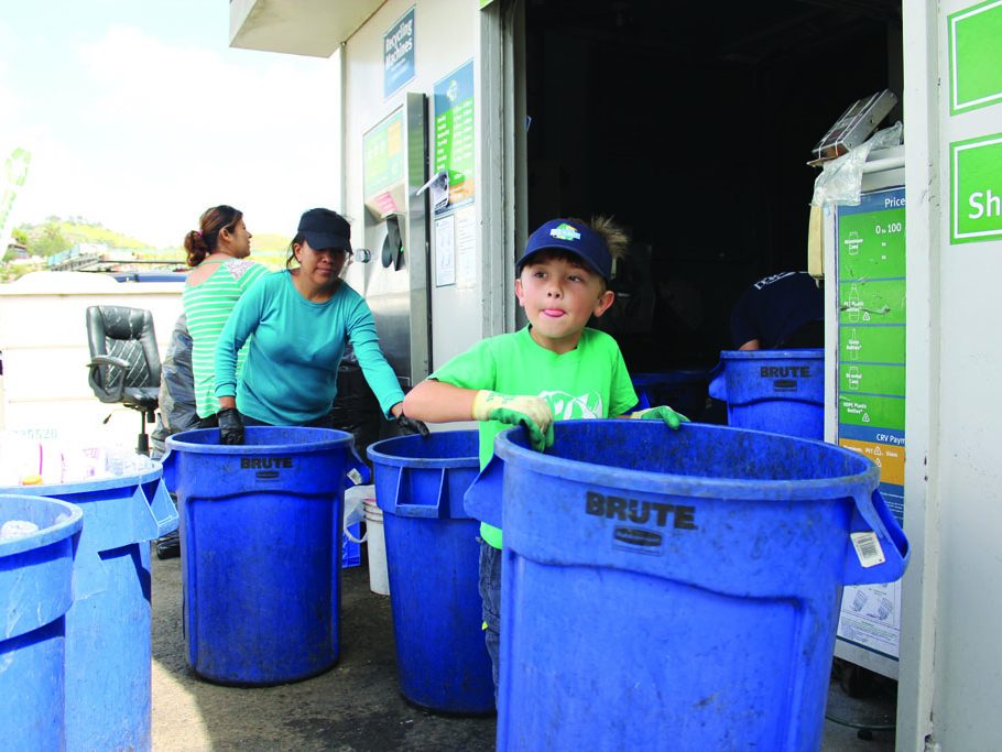 Hickman and his dad collects money from a heavy recycling load. (Taya Buehler-Reagan)