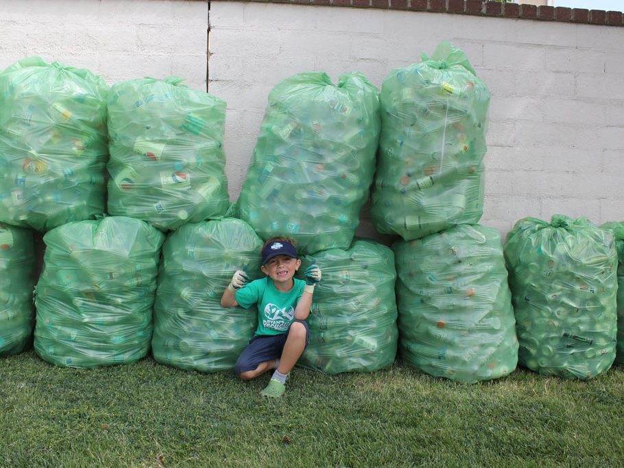 Ryan poses in front of his 20+ bags on recycling (Taya Buehler-Reagan)