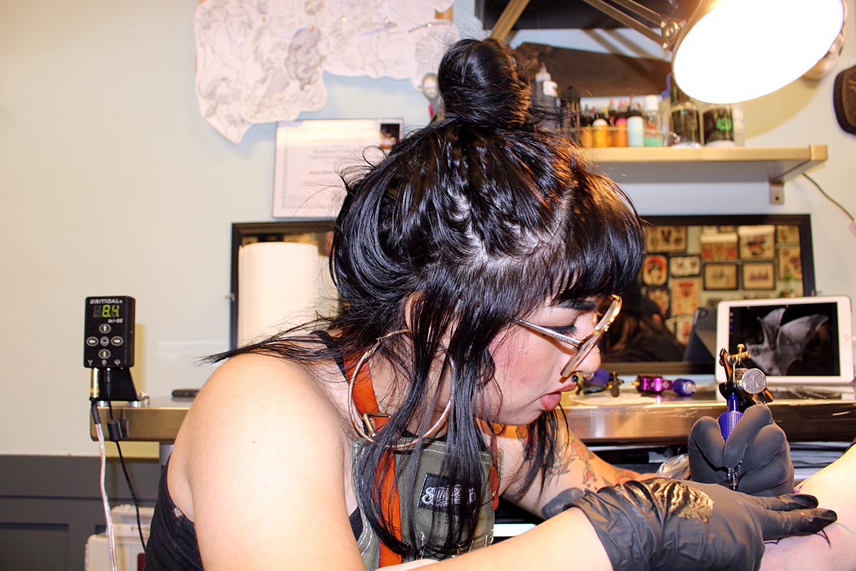 Sanchez tattooing a client at Black Palm Tattoo. (Ashley Hern)