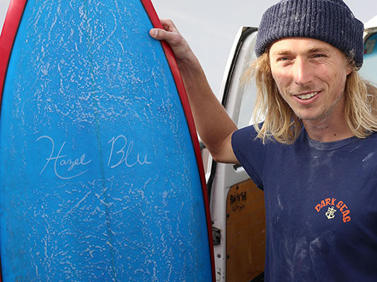 Hansen showing off the first board he created start to finish, titled after his daughter.