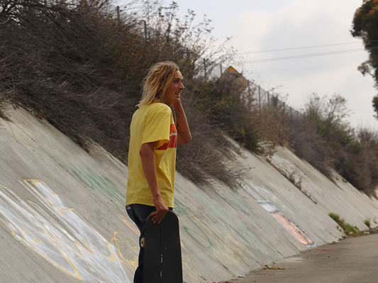 Tucking hair behind his ear as he scopes out the ride.